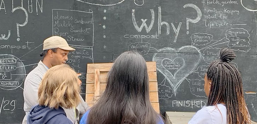 students in front of chalk board