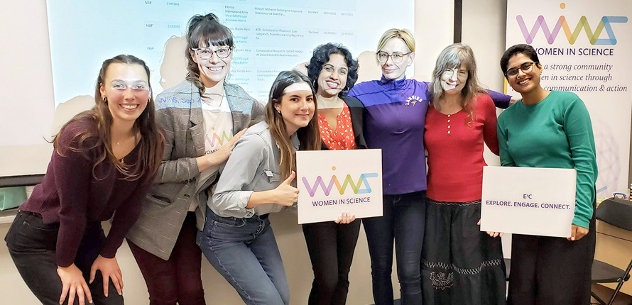 WinS group photo in front of classroom whiteboard